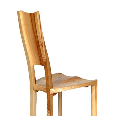 Blagr - rear view of carved dining chair in ash